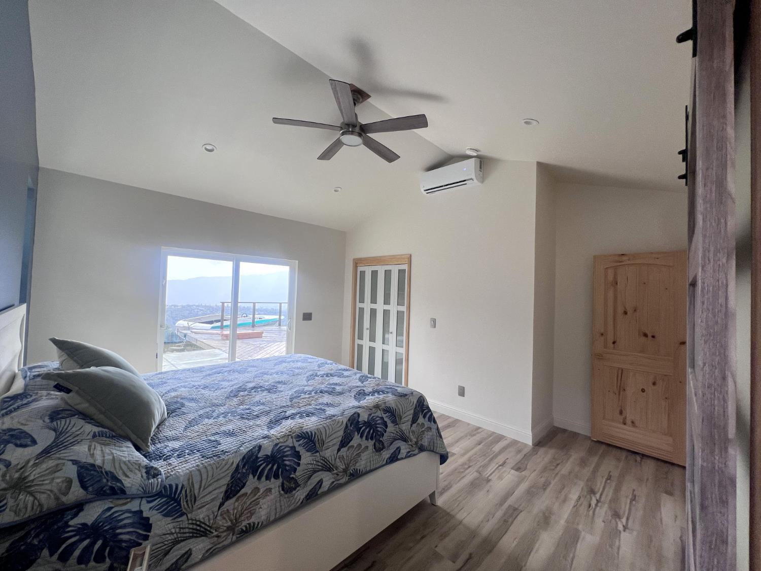 51571 Coyote Ridge Road Oakhurst, CA 93644 - Photo 21 of 81 a bedroom with a bed and wooden floor