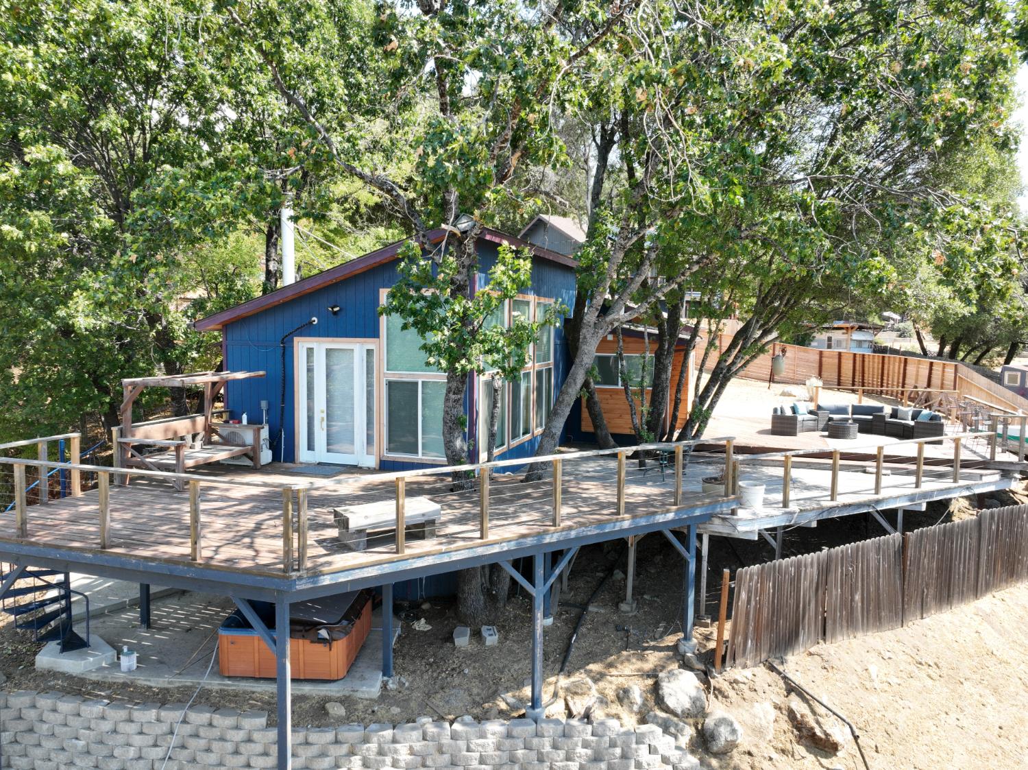 51571 Coyote Ridge Road Oakhurst, CA 93644 - Photo 26 of 81 a backyard of a house with table and chairs