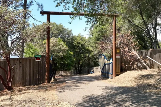a kitchen with granite countertop lots of counter top space a sink a window and stainless steel appliances
