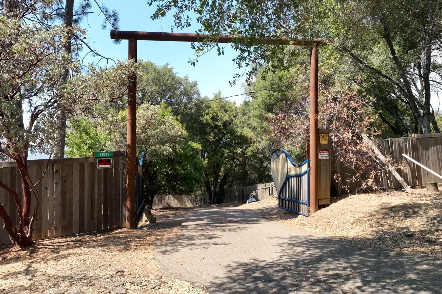 51571 Coyote Ridge Road Oakhurst, CA 93644 - Photo 3 of 81 a view of a house with a tree in the background