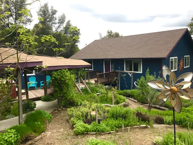 a living room with furniture a bookshelf and a flat screen tv