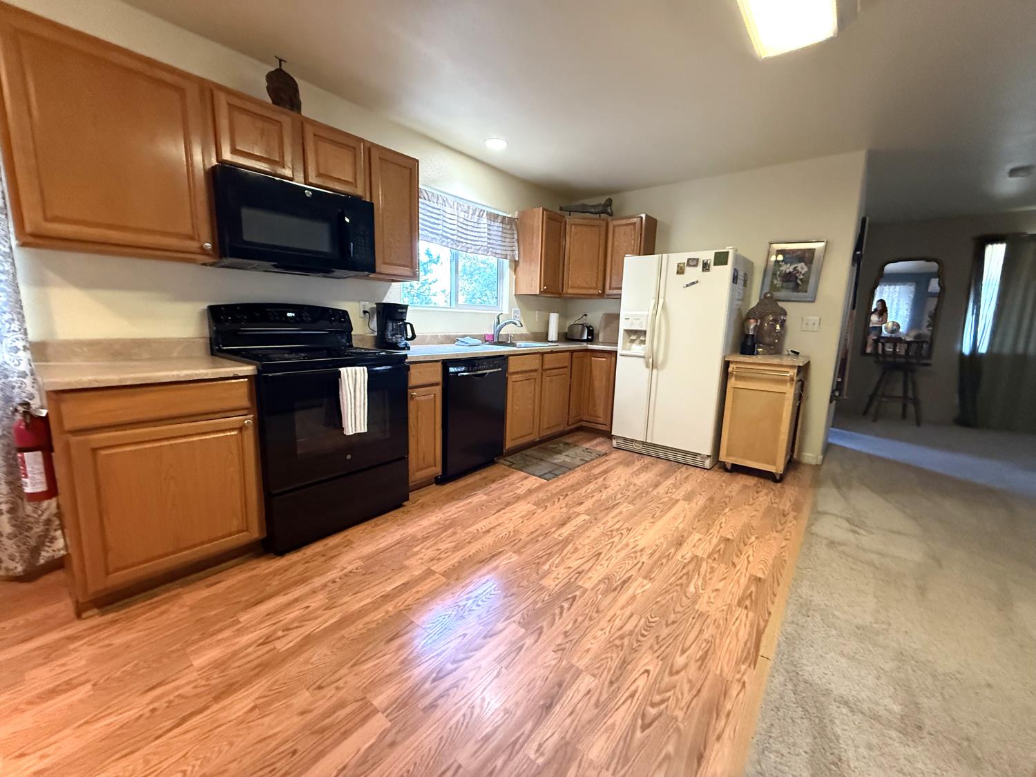 51571 Coyote Ridge Road Oakhurst, CA 93644 - Photo 35 of 81 a kitchen with a sink wooden floor and stainless steel appliances