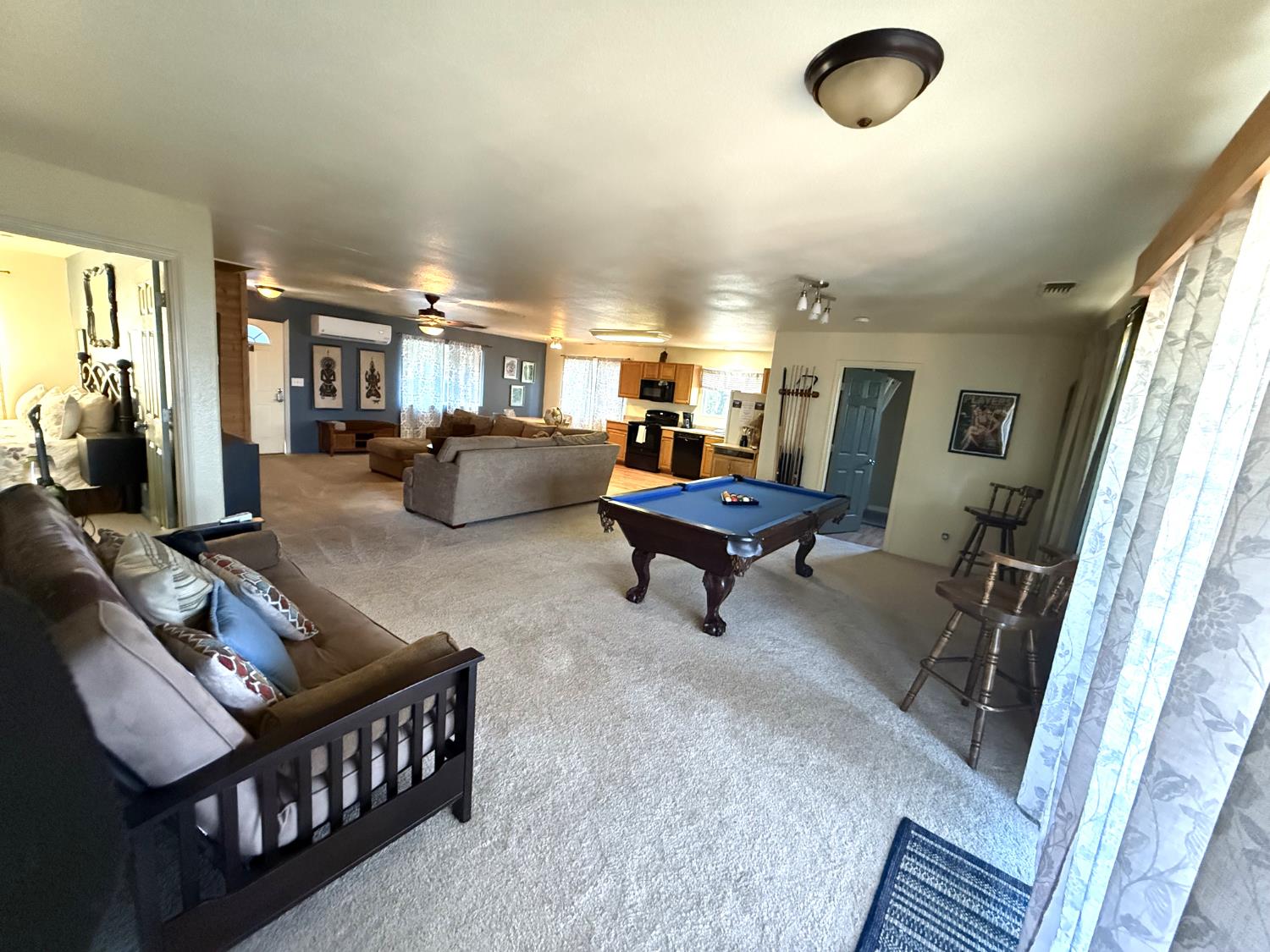 51571 Coyote Ridge Road Oakhurst, CA 93644 - Photo 36 of 81 a living room with furniture and a flat screen tv
