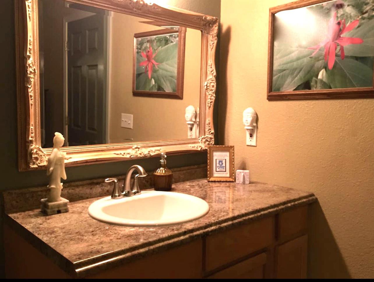 51571 Coyote Ridge Road Oakhurst, CA 93644 - Photo 40 of 81 a bathroom with a sink and a mirror