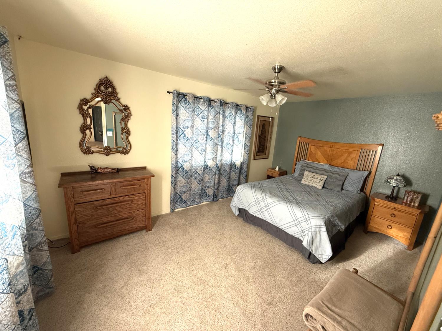 51571 Coyote Ridge Road Oakhurst, CA 93644 - Photo 41 of 81 a bedroom with a bed and a chandelier