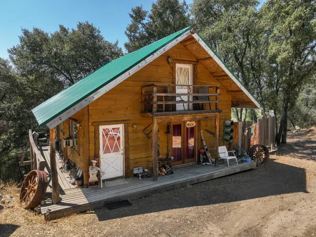 a view of a balcony with wooden floor and iron fence