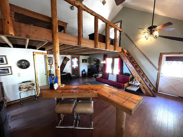 a view of a livingroom with wooden floor and a flat screen tv