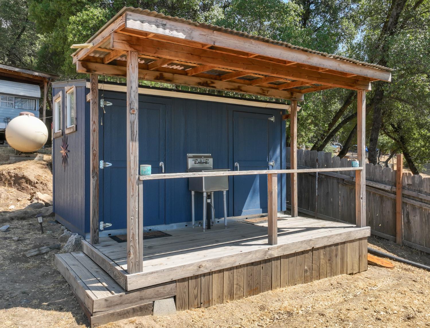 51571 Coyote Ridge Road Oakhurst, CA 93644 - Photo 65 of 81 a view of a balcony with wooden floor and iron fence
