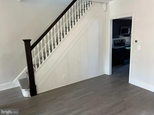 a view of an entryway with wooden floor and stairs