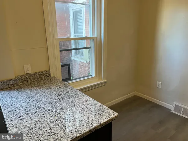 view of a room that has a bench in it