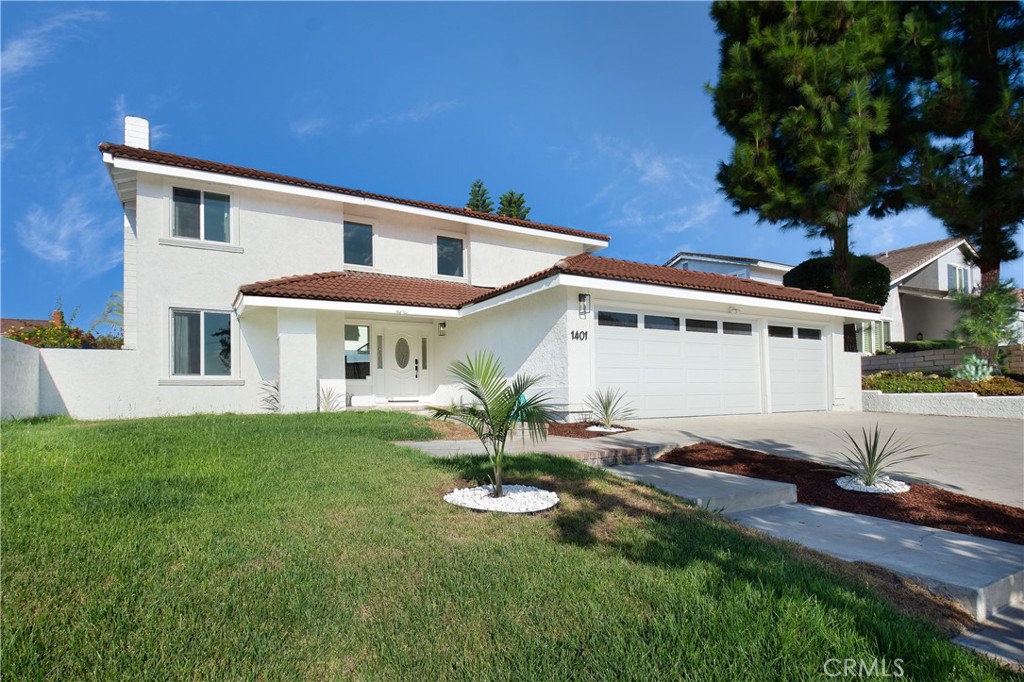 1401 Carleton Way Fullerton, CA 92833 - Photo 1 of 1 a front view of a house with a garden and plants