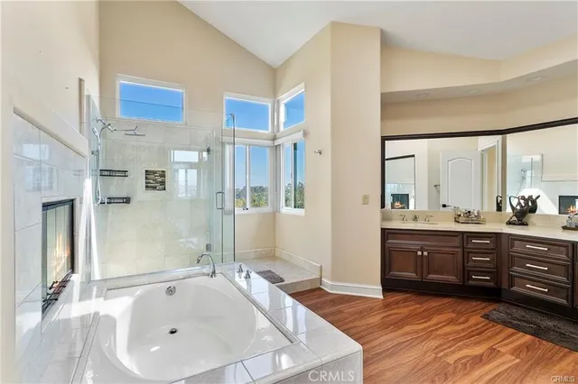 a bathroom with a tub sink and mirror