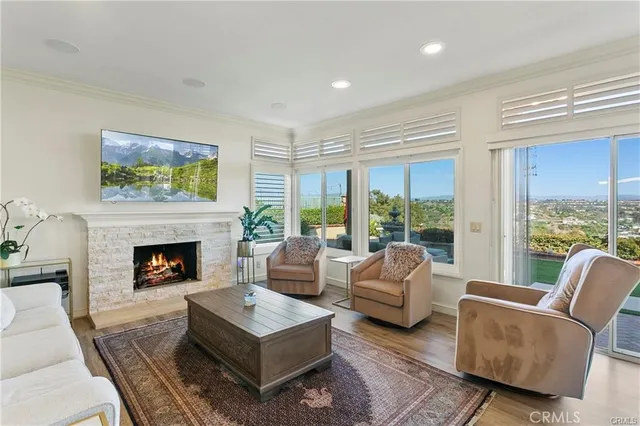 a living room with furniture large window and a fireplace
