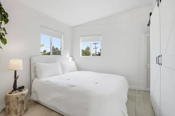 a bedroom with a large bed and a window