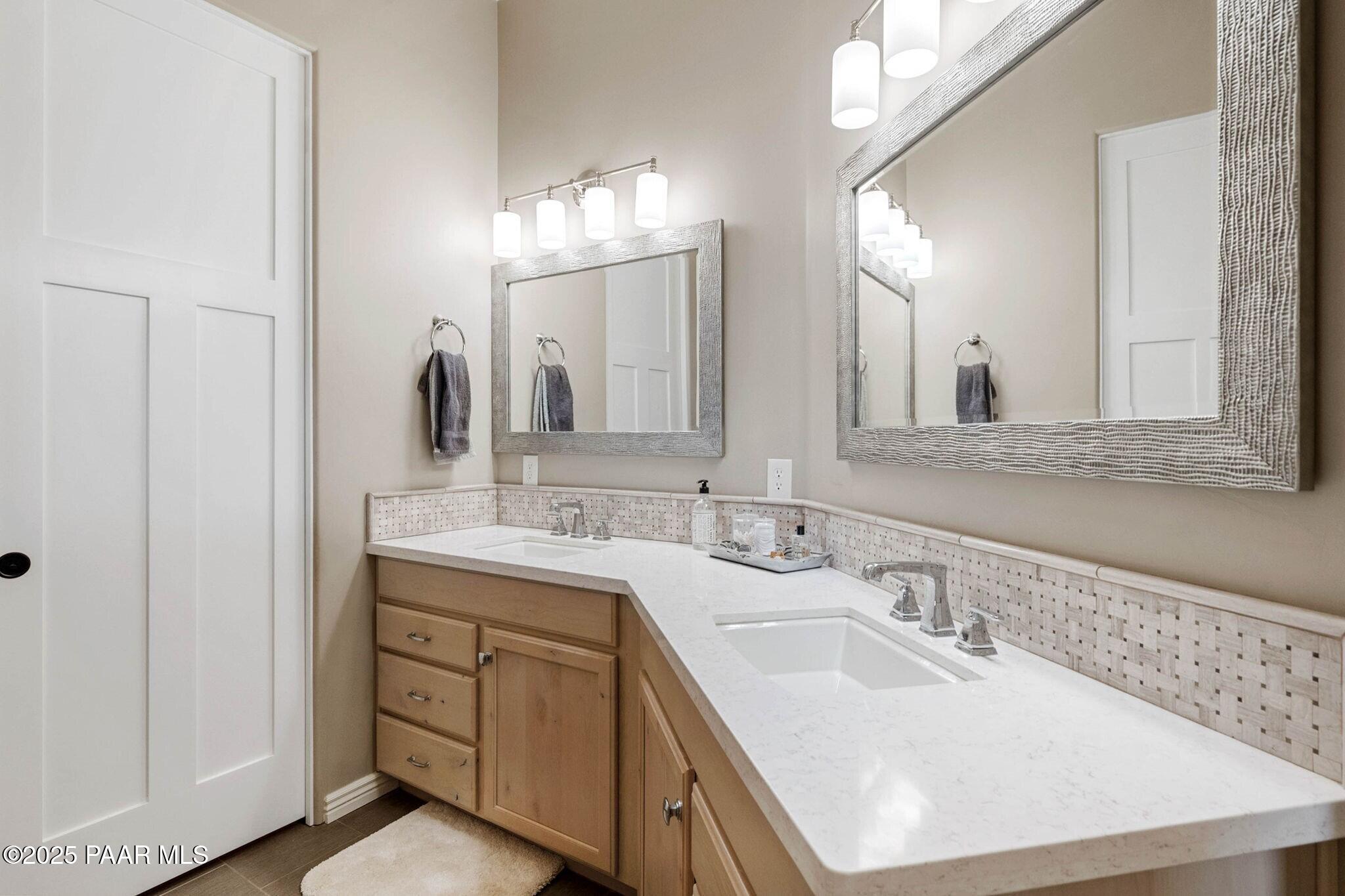 9309 North Callahan Road Prescott, AZ 86305 - Photo 18 of 55 a bathroom with double vanity sinks and a mirror