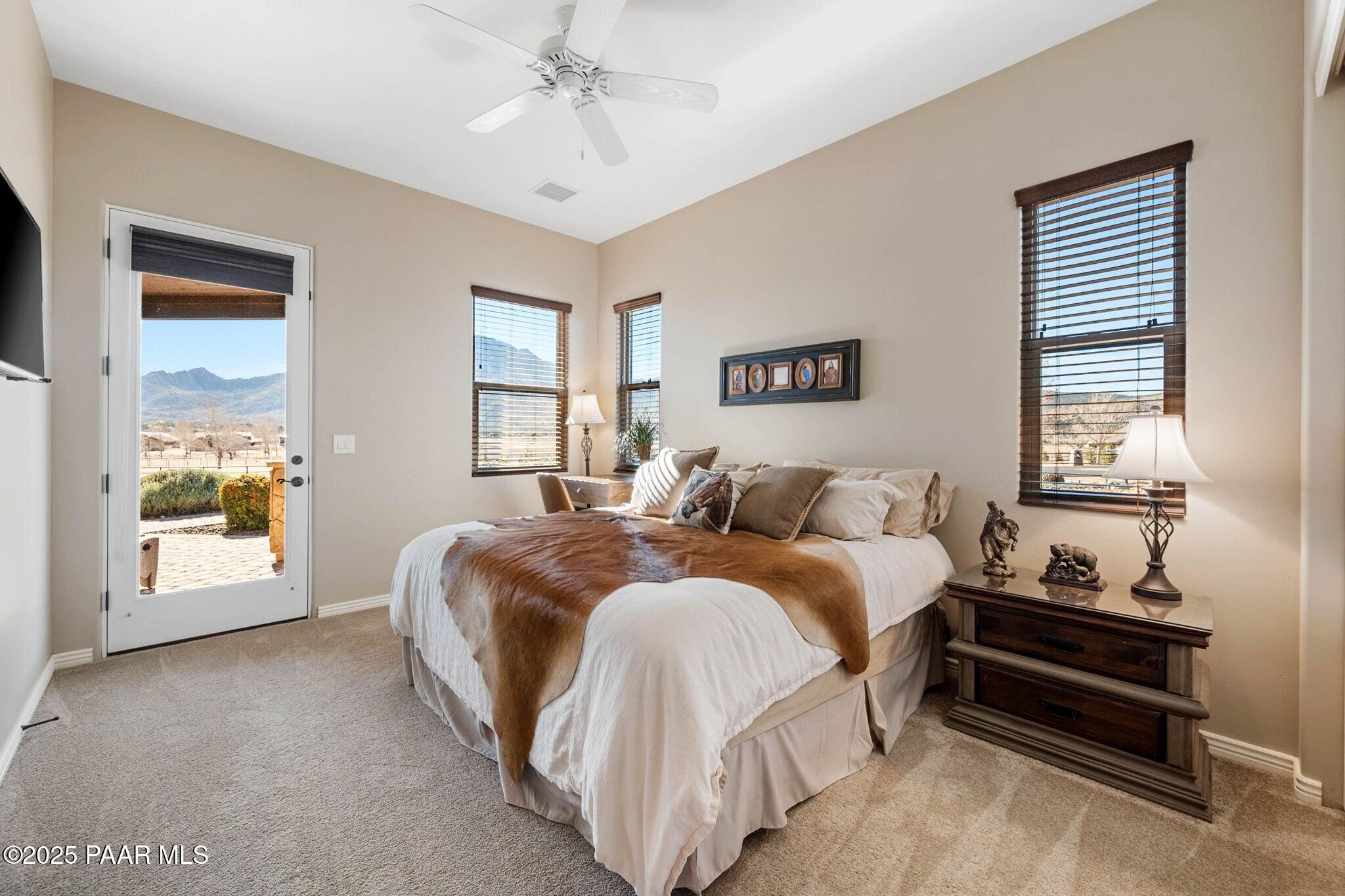 9309 North Callahan Road Prescott, AZ 86305 - Photo 25 of 55 a spacious bedroom with a bed and window
