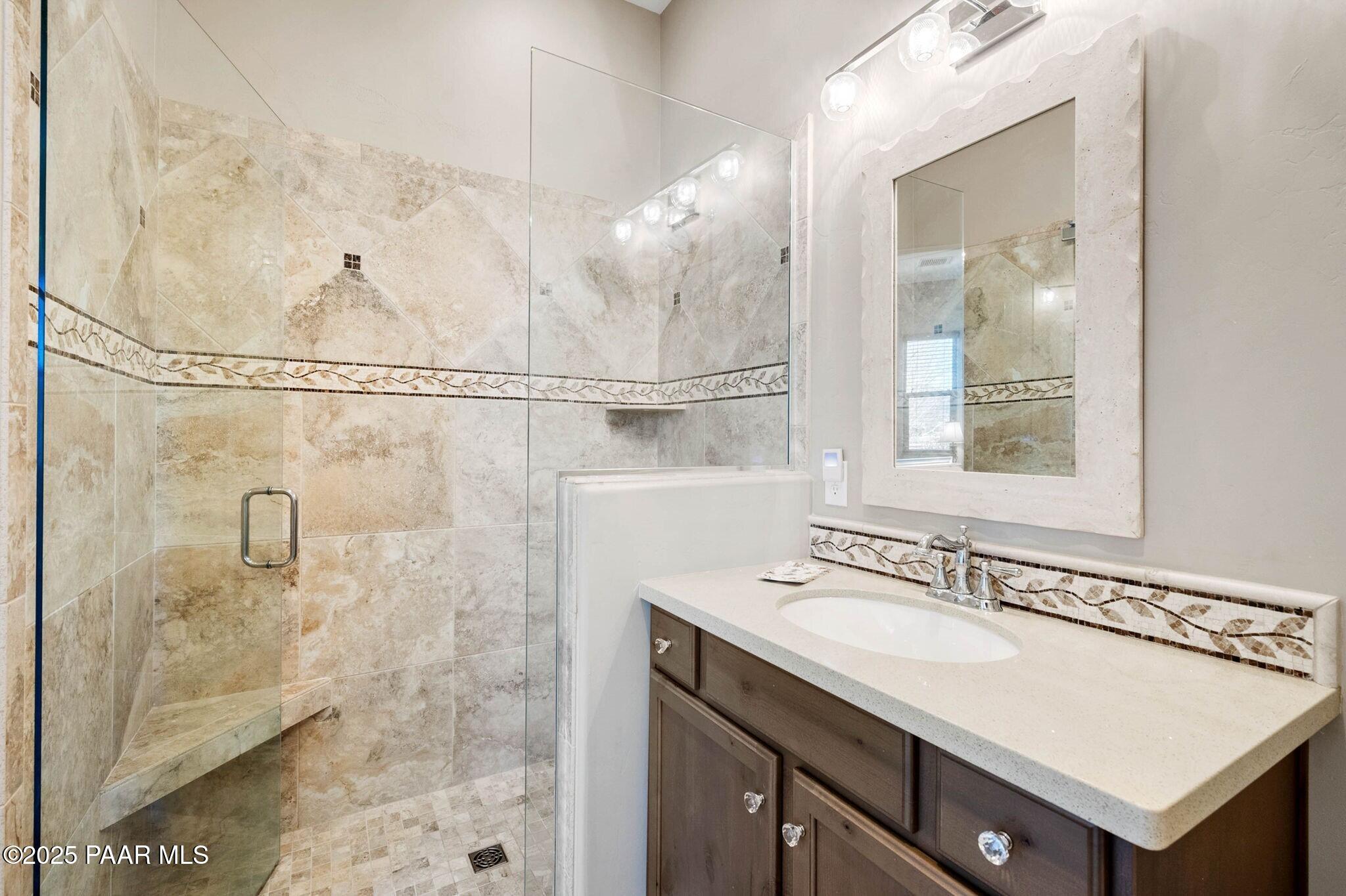 9309 North Callahan Road Prescott, AZ 86305 - Photo 26 of 55 a bathroom with a sink vanity and a mirror