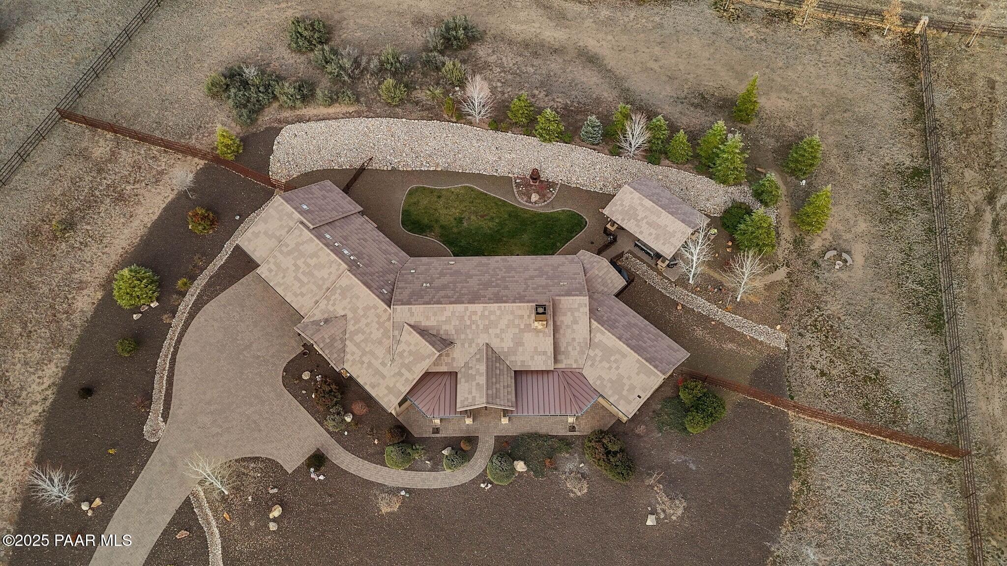 9309 North Callahan Road Prescott, AZ 86305 - Photo 35 of 55 an aerial view of a house with a yard and tennis court
