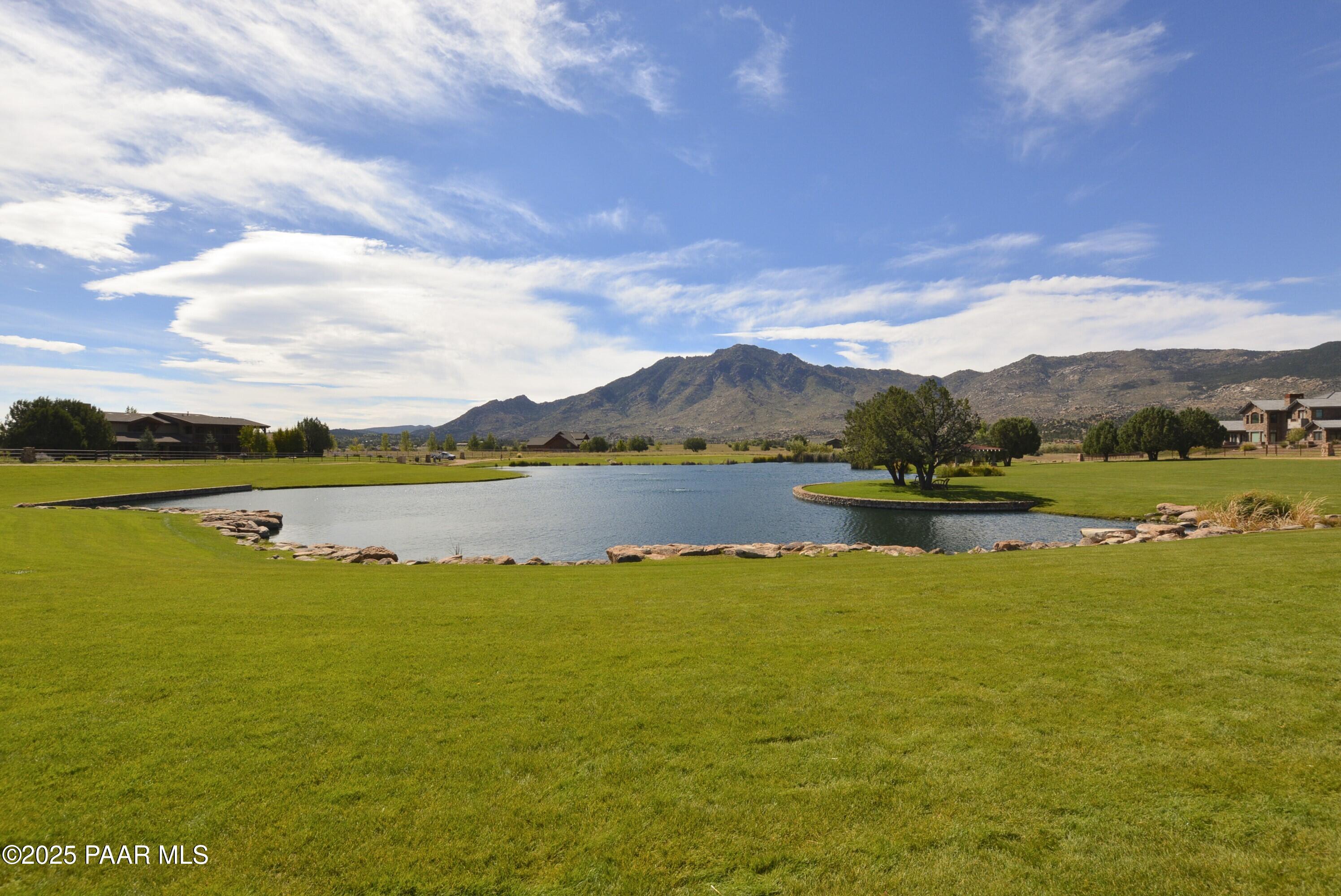 9309 North Callahan Road Prescott, AZ 86305 - Photo 46 of 55 a view of a lake with houses in the back