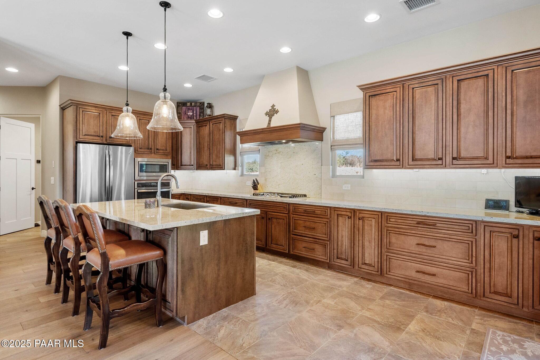 9309 North Callahan Road Prescott, AZ 86305 - Photo 5 of 55 a kitchen with a sink a center island stainless steel appliances and cabinets
