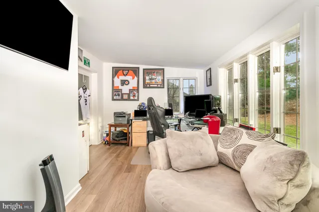 a living room with furniture fireplace and flat screen tv