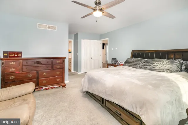 a large bed sitting in a bedroom and dresser