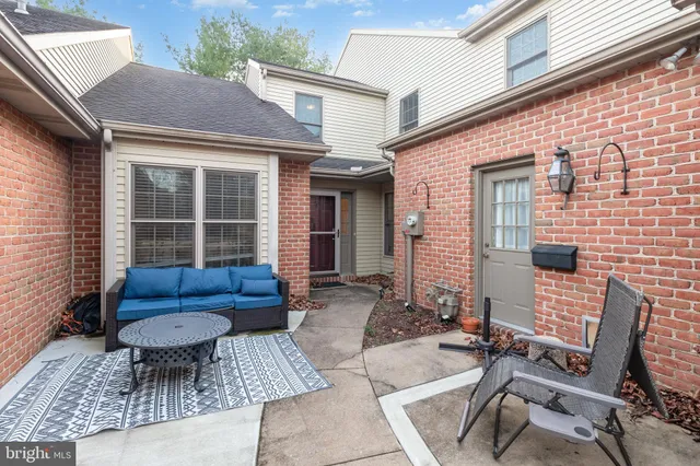 a view of a patio with couple of chairs and a couch