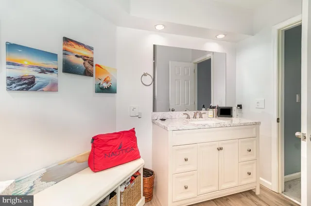 a bathroom with a sink vanity and a mirror
