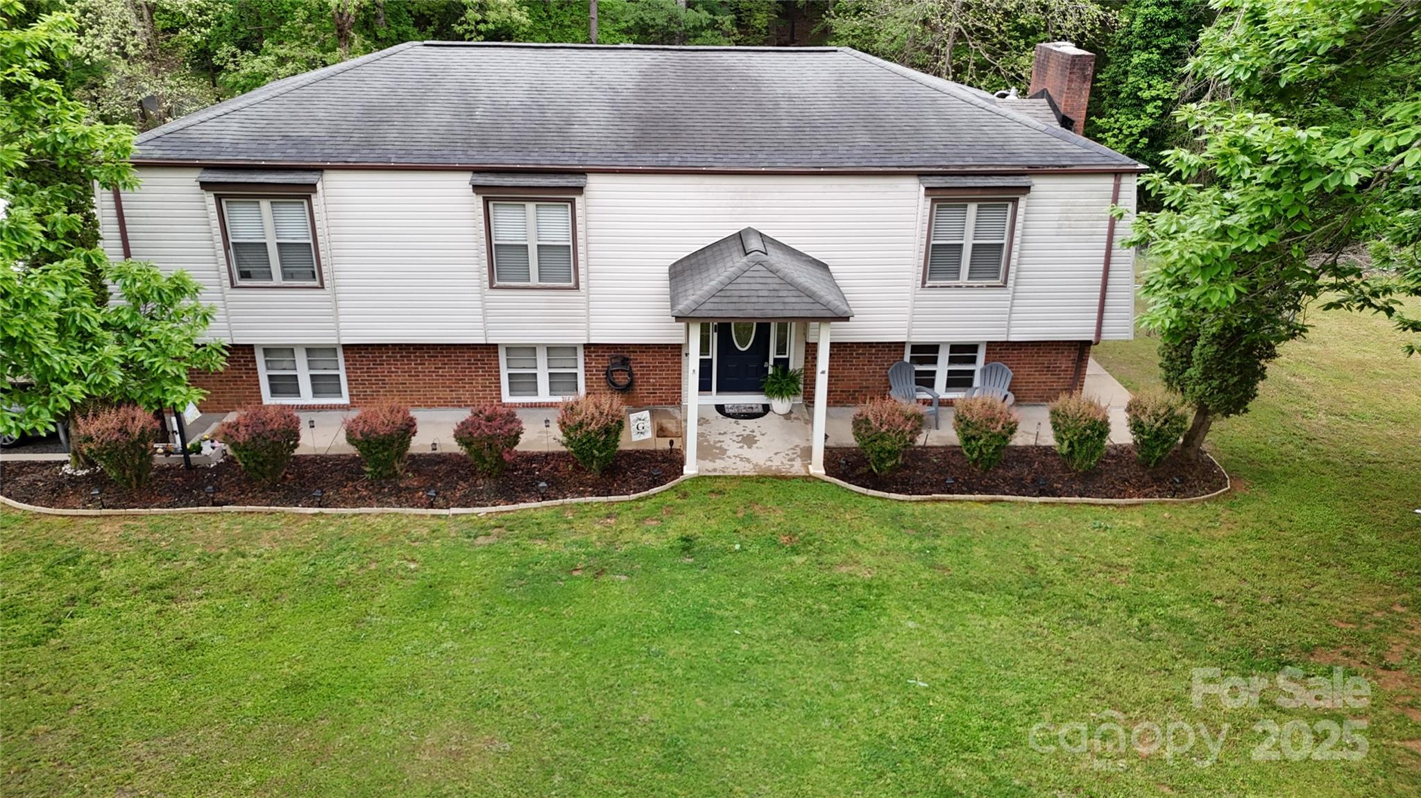 3816 Redman Road Shelby, NC 28150 - Photo 2 of 39 a aerial view of a house with table and chairs under an umbrella