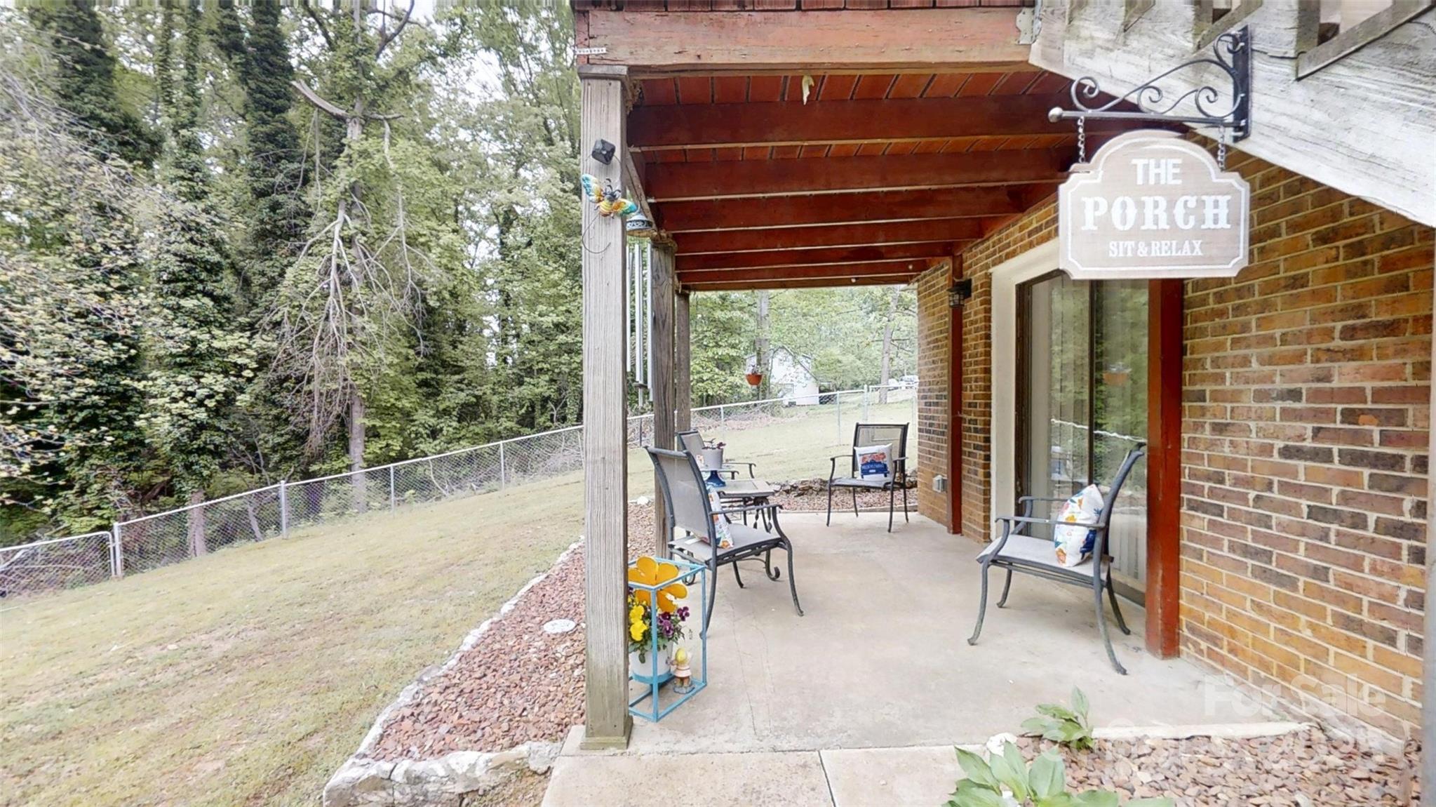 3816 Redman Road Shelby, NC 28150 - Photo 27 of 39 a view of a patio with a table chairs and wooden fence