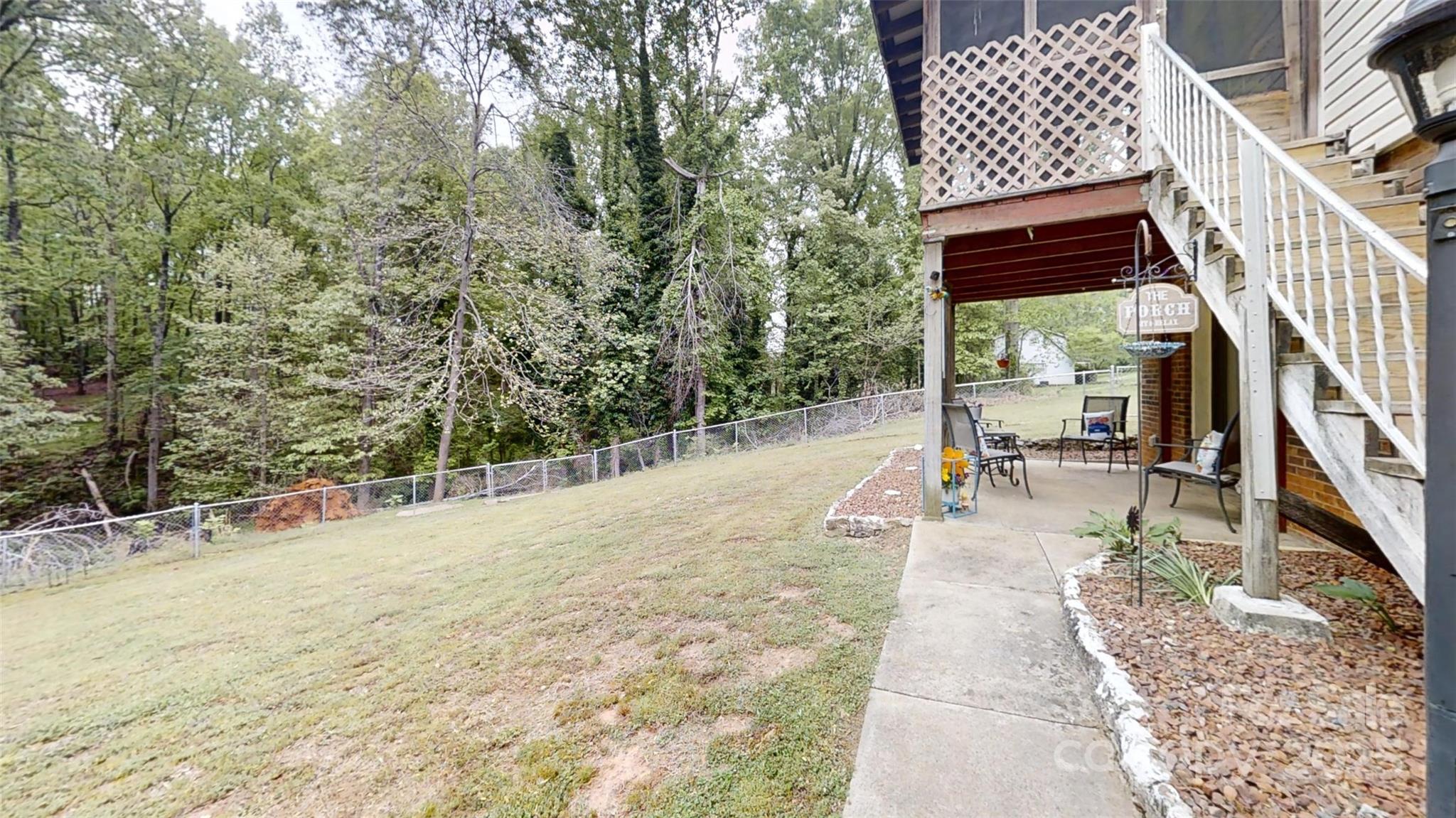 3816 Redman Road Shelby, NC 28150 - Photo 28 of 39 a view of a patio with table and chairs with wooden fence and plants