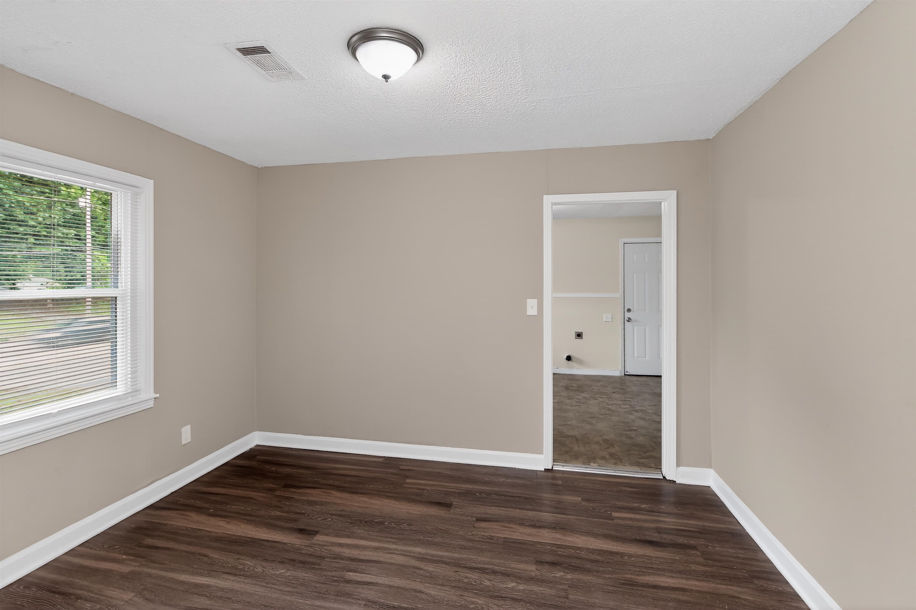 318 East Raines Road Memphis, TN 38109 - Photo 11 of 28 Interior room featuring wood-finish flooring, neutral wall tones, and white trim