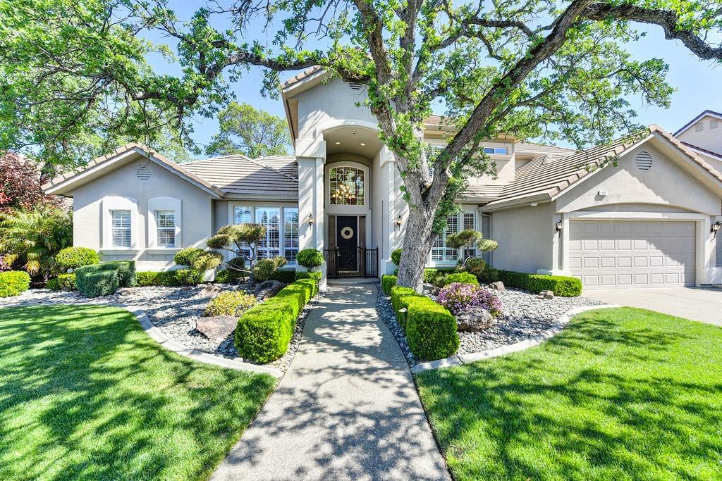 137 Feather Falls Circle Folsom, CA 95630 - Photo 1 of 1 a front view of a house with a garden and trees