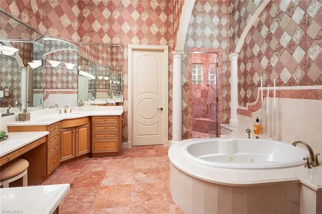 a bathroom with a tub sink and mirror