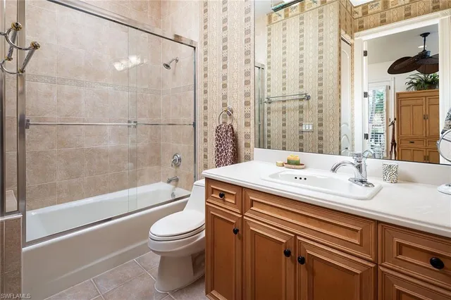 a bathroom with a toilet a sink and a mirror