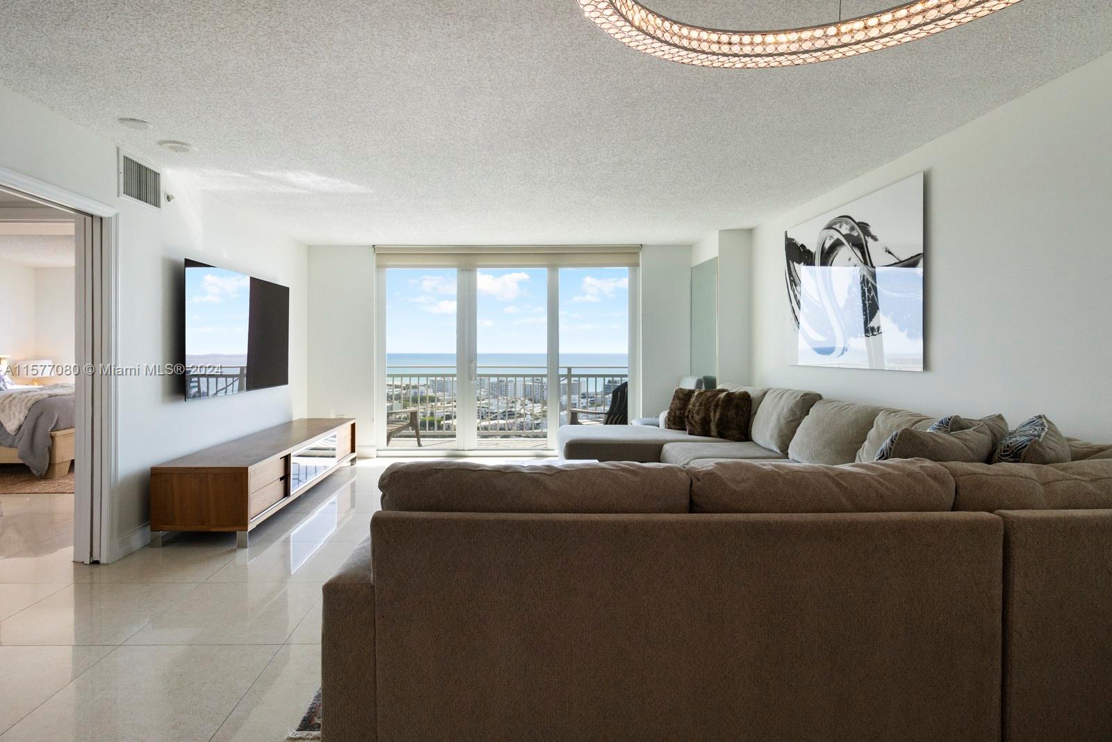 90 Alton Road, Unit 2907 Miami Beach, FL 33139 - Photo 11 of 18 a living room with furniture and a large window