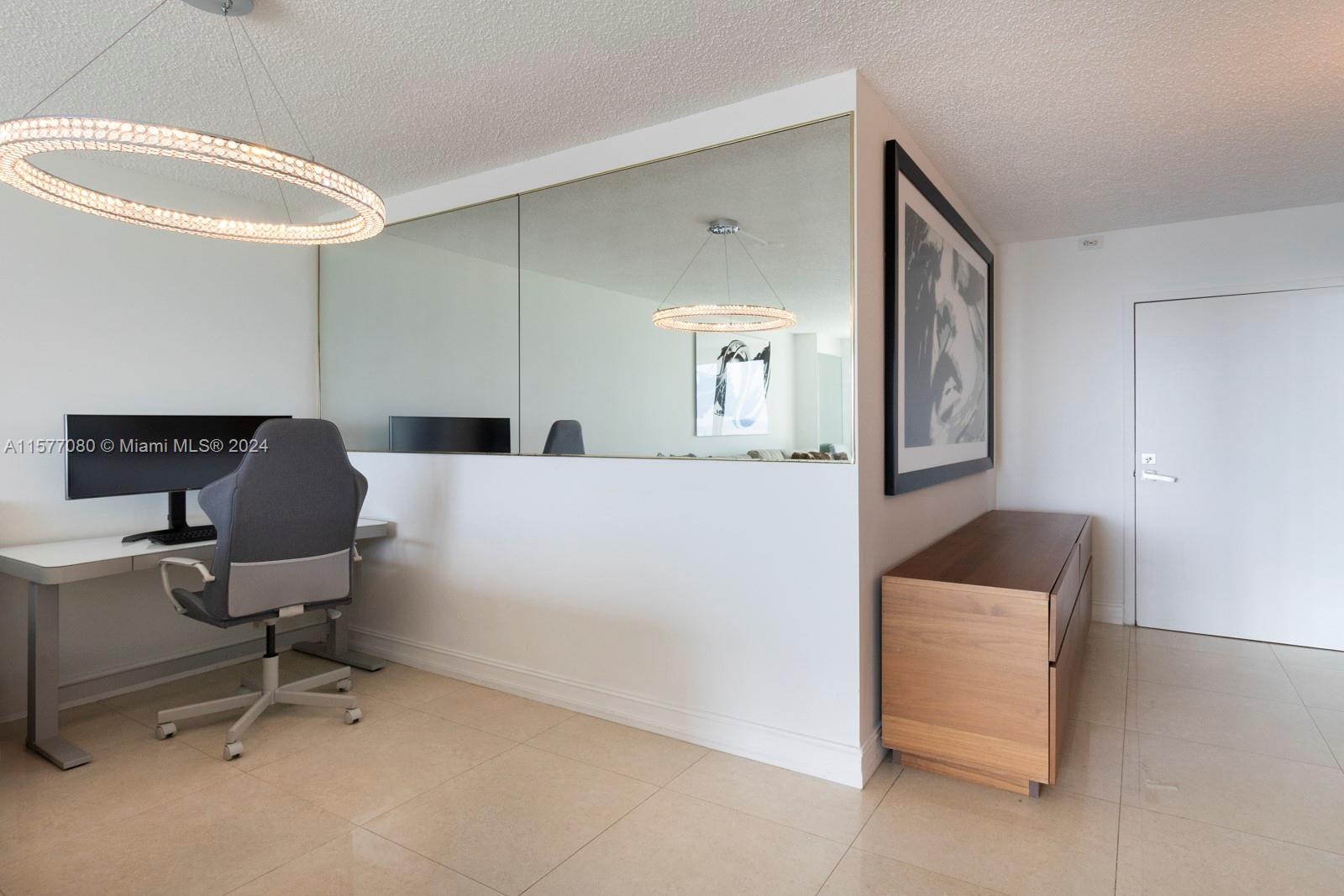 90 Alton Road, Unit 2907 Miami Beach, FL 33139 - Photo 14 of 18 a workspace with furniture and mirror