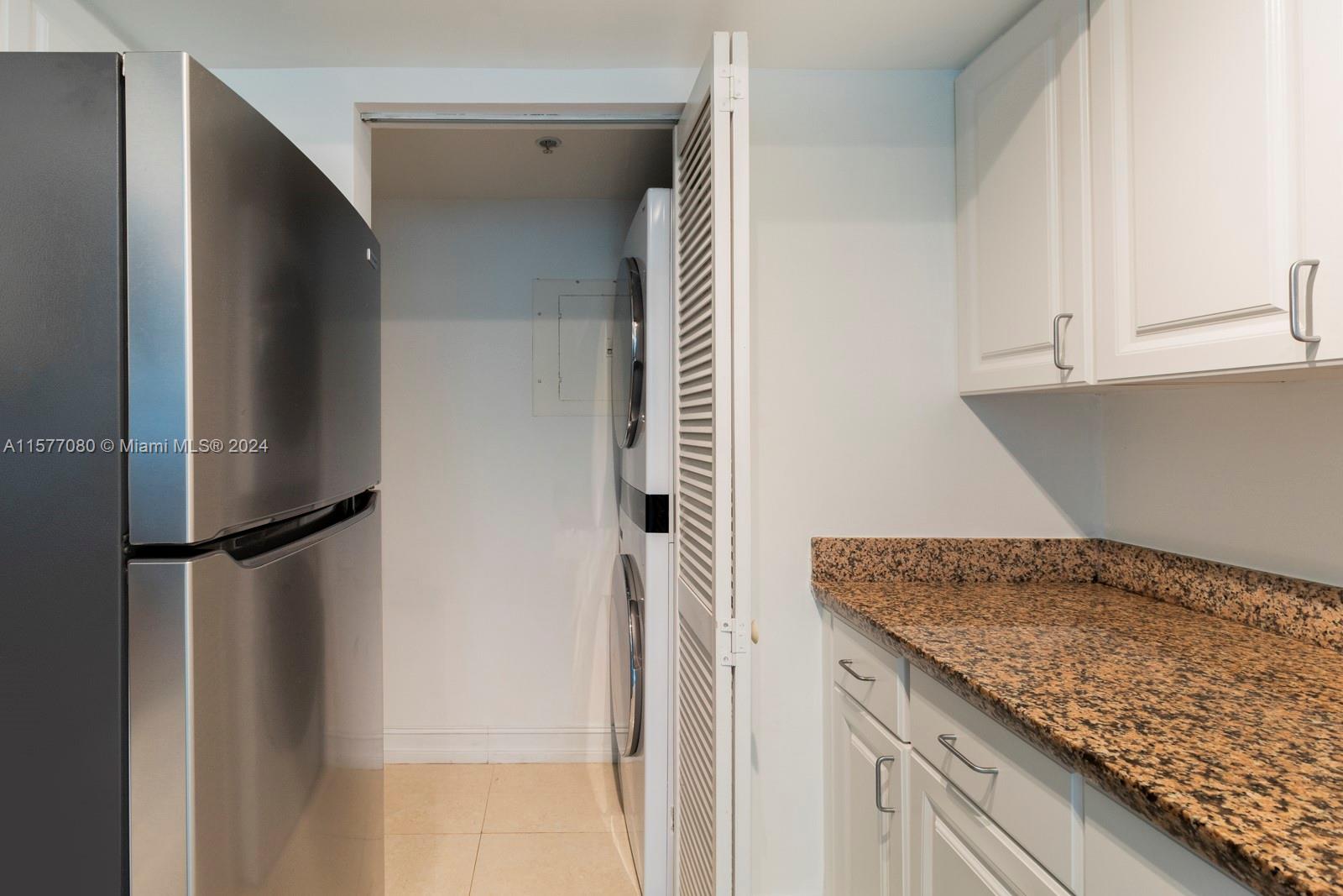 90 Alton Road, Unit 2907 Miami Beach, FL 33139 - Photo 15 of 18 a kitchen with a refrigerator and cabinets