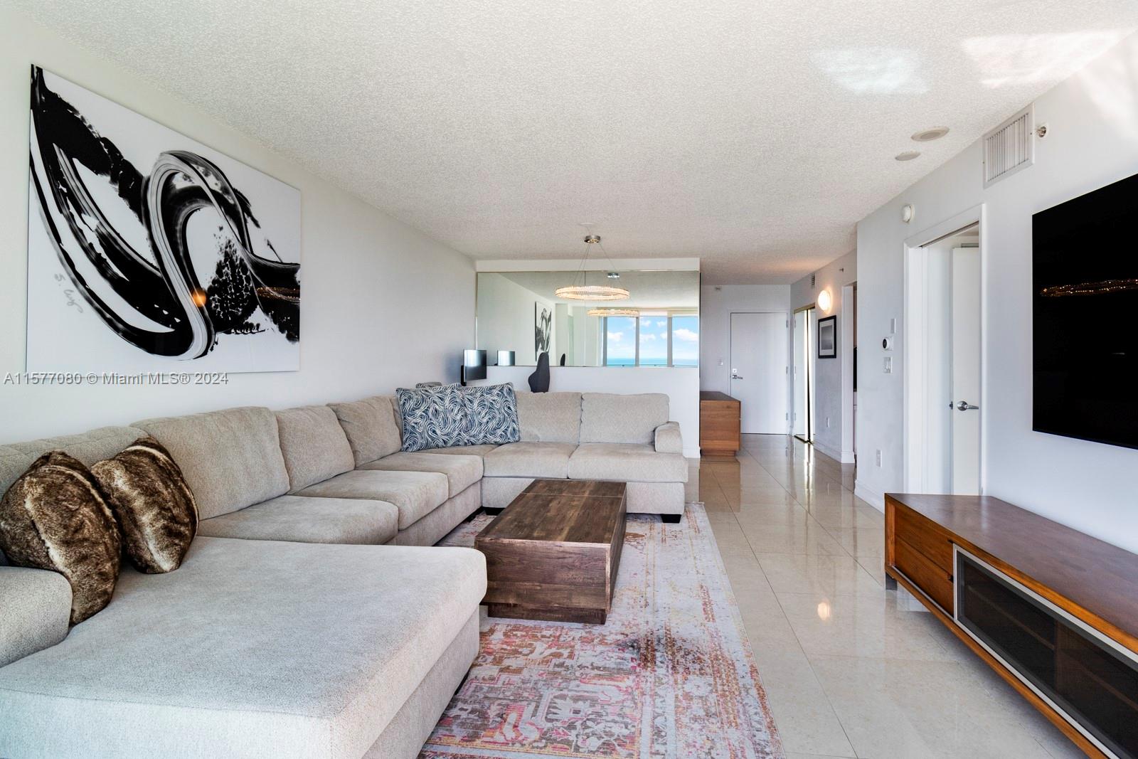 90 Alton Road, Unit 2907 Miami Beach, FL 33139 - Photo 6 of 18 a living room with furniture and a flat screen tv