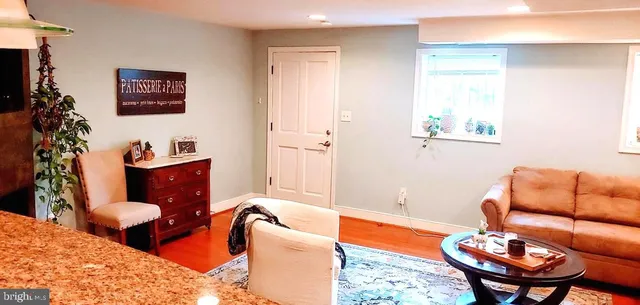 a living room with furniture a rug and a lamp