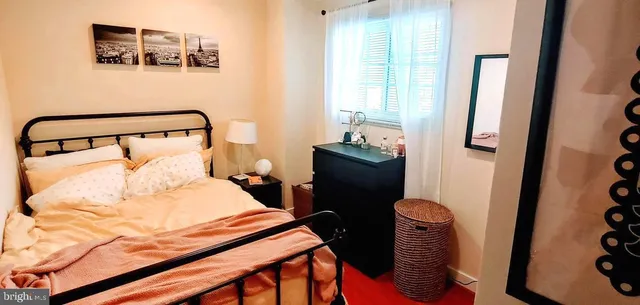 a bedroom with a bed and a mirror