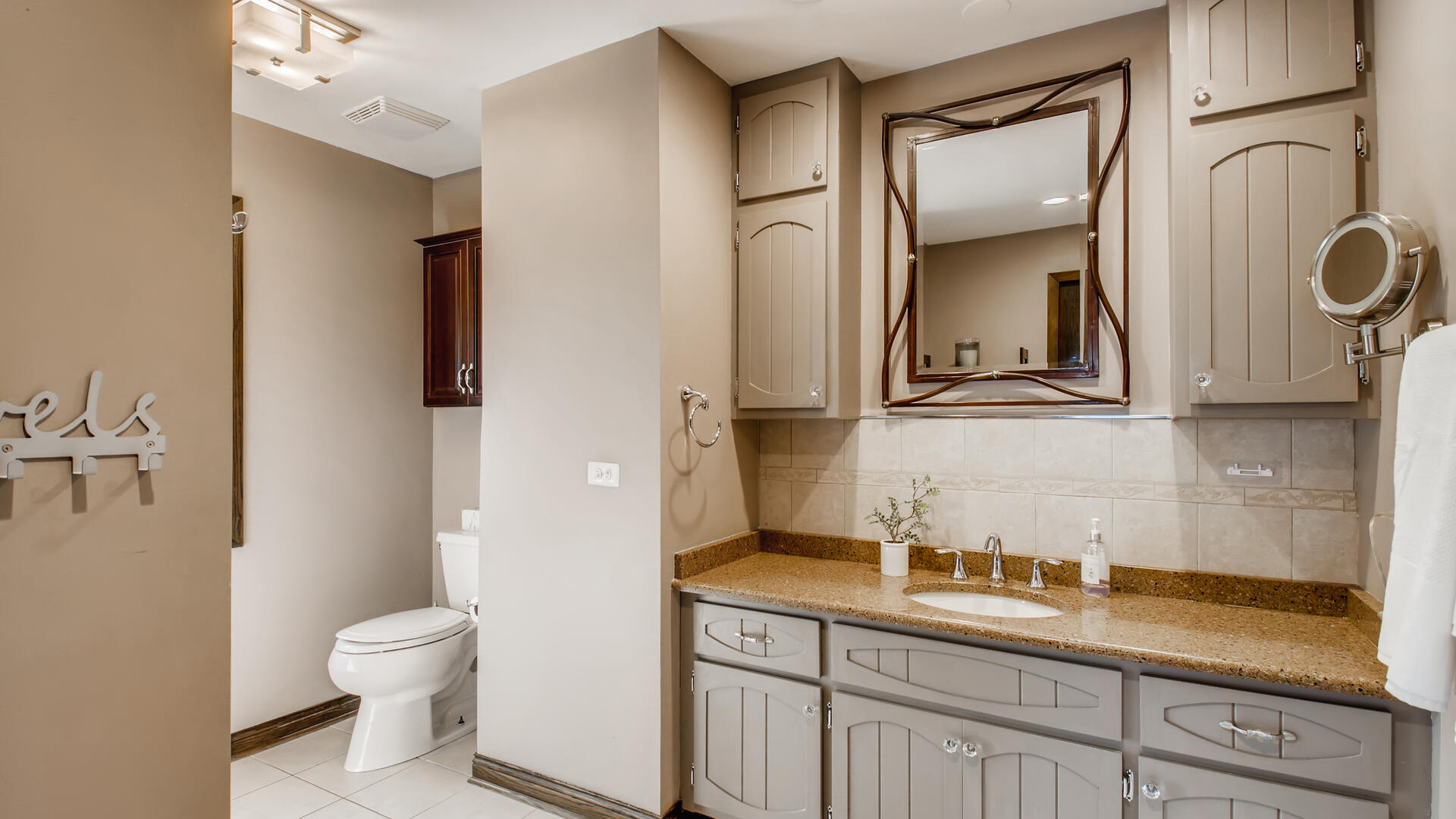 4511 Wolf Road Western Springs, IL 60558 - Photo 14 of 26 a bathroom with a granite countertop toilet sink and mirror