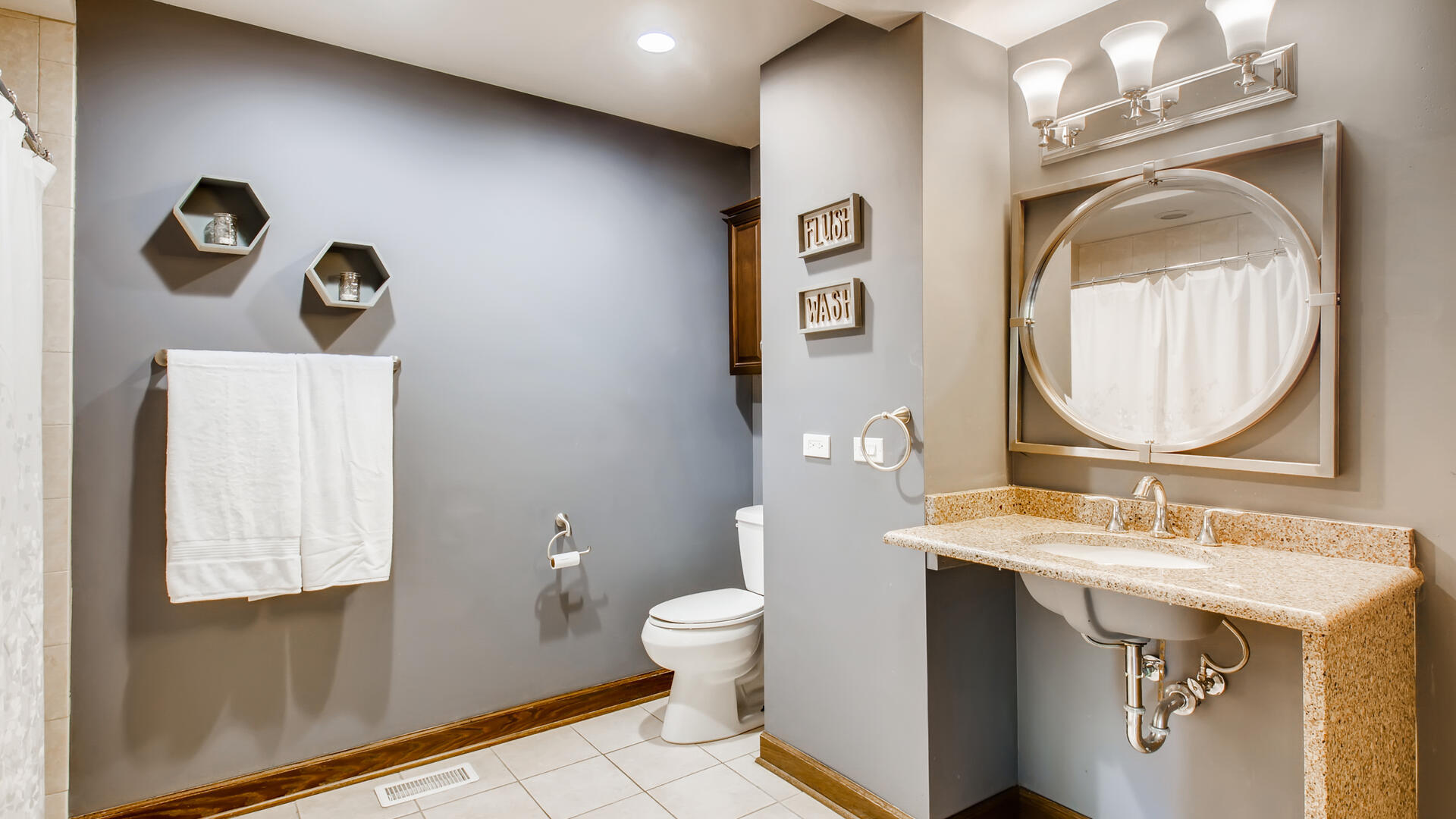 4511 Wolf Road Western Springs, IL 60558 - Photo 22 of 26 a bathroom with a toilet sink vanity and mirror