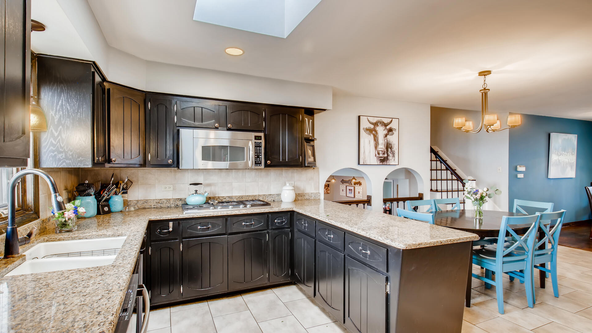 4511 Wolf Road Western Springs, IL 60558 - Photo 9 of 26 a kitchen with a sink stove and microwave
