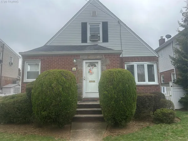 a view of a house in front of a house with a garden