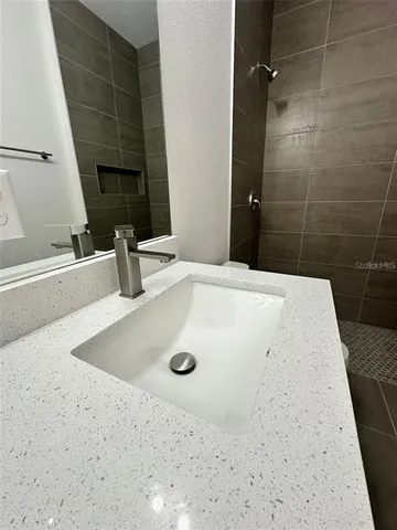a bathroom with a granite countertop sink