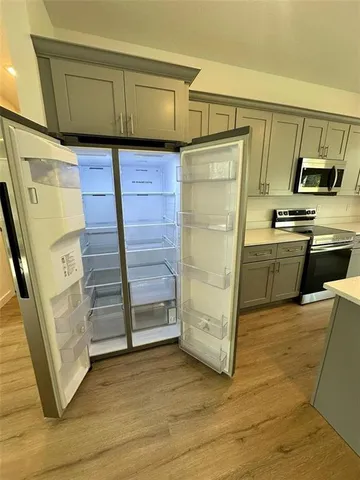 a kitchen with stainless steel appliances a refrigerator and a stove