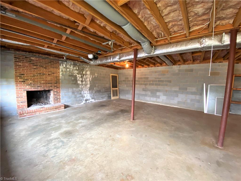 933 Lemons Road Stokesdale, NC 27357 - Photo 20 of 33 Wood burning fireplace in basement