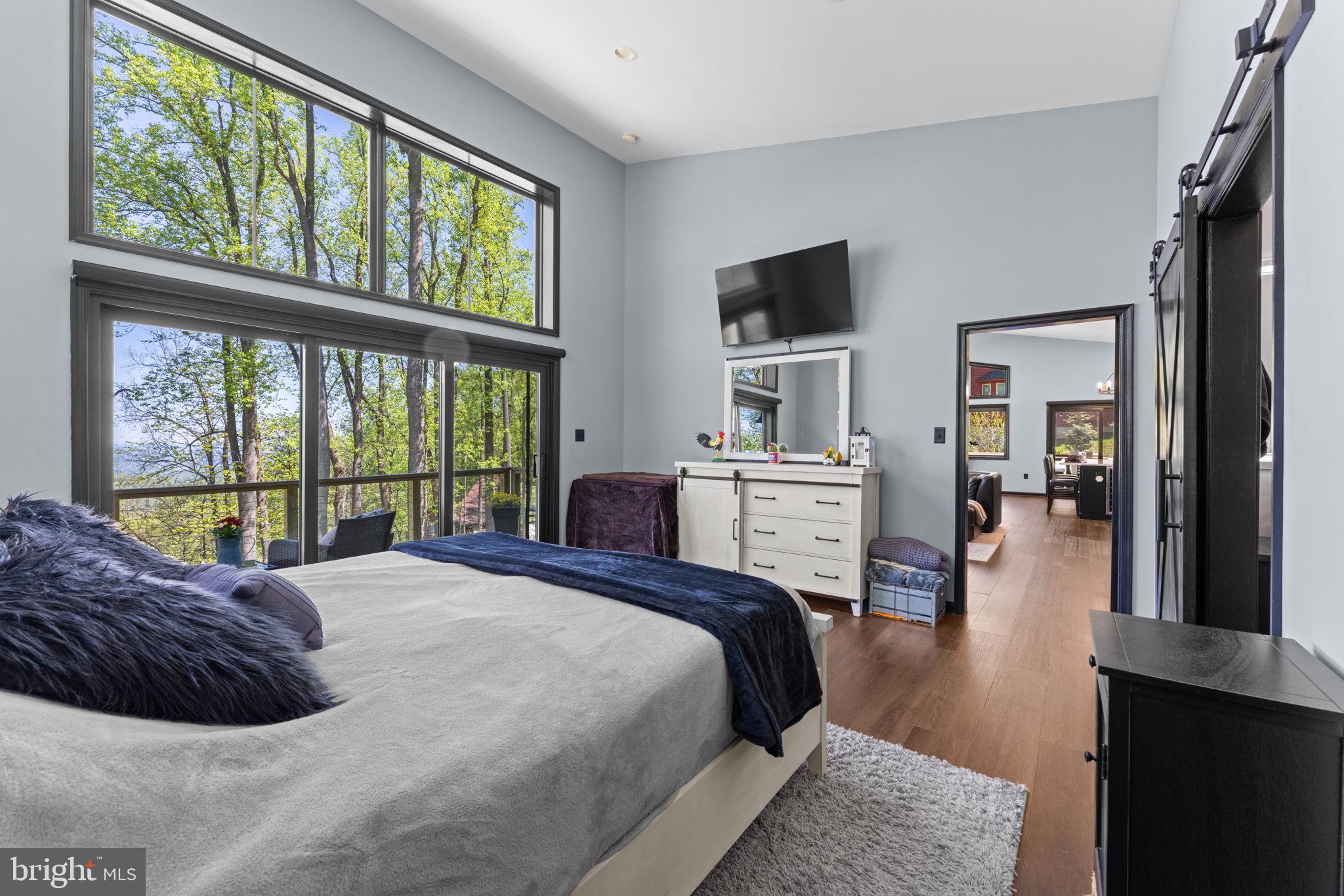 753 Club House Road Front Royal, VA 22630 - Photo 32 of 98 a large bedroom with a large bed and a large window