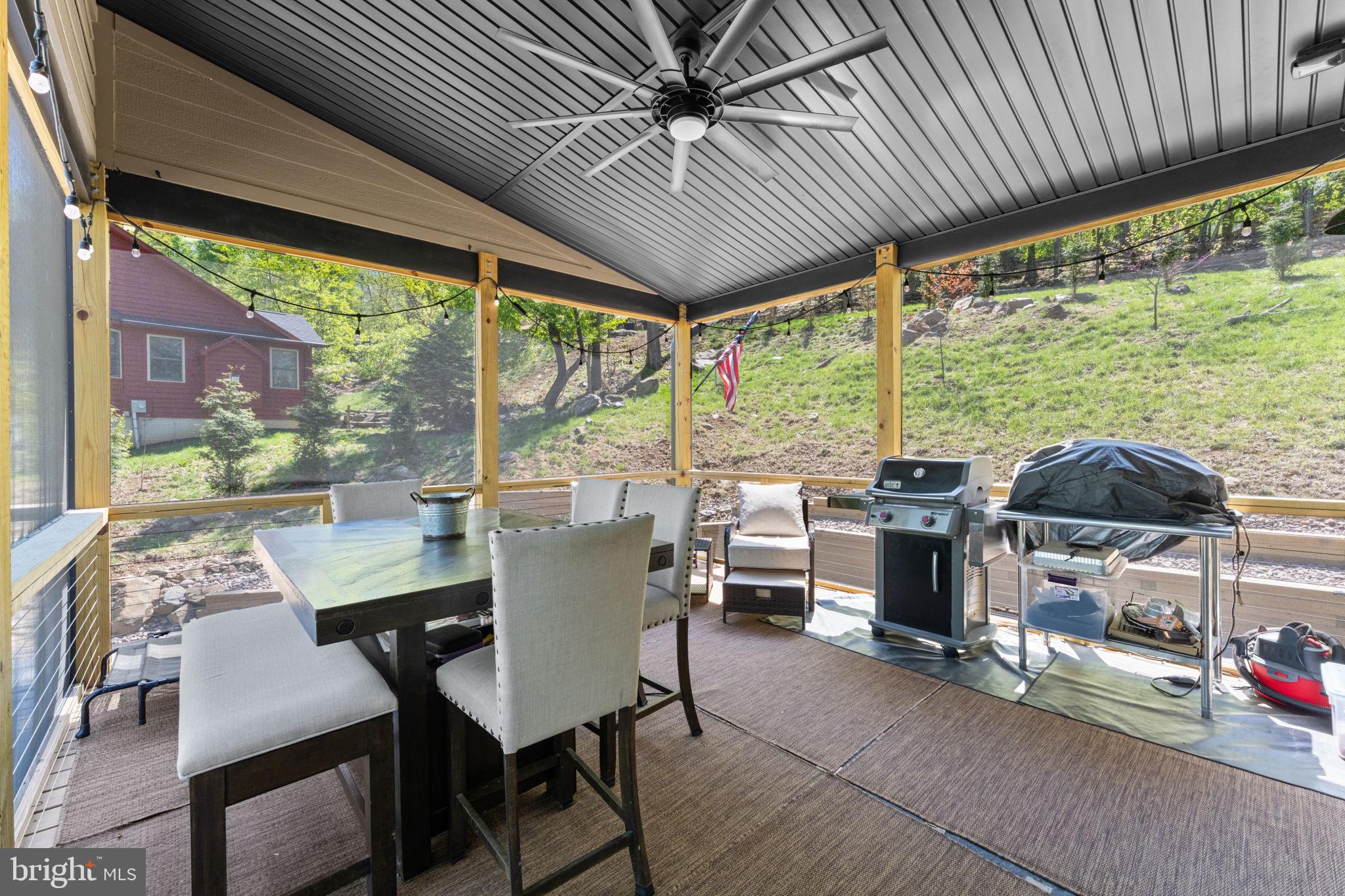 753 Club House Road Front Royal, VA 22630 - Photo 59 of 98 a view of a patio with a table chairs and a grill